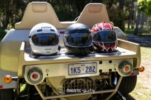 Three Motorcycle Helmets (white, Black, Red) Placed On The Rear Of A Vehicle With Western Australia License Plate 1ks 282 In A Sunny Outdoor Setting.