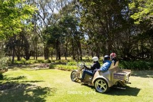 Two People Riding A Motorcycle With A Sidecar Labeled 