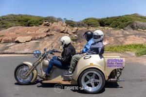 Three People Ride On A Tan Trike With A 